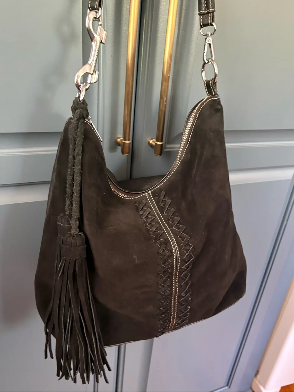 black suede Coco + Carmen hobo bag whipstitching and fringe tassels